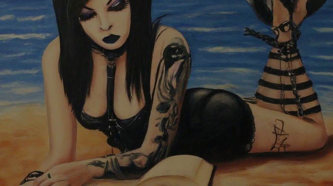 A Goth Babe Reading An ARC Copy Of A New Horror Book At The Beach